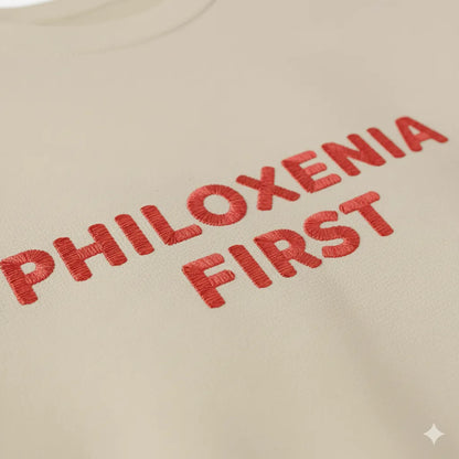Close-up of Philoxenia First Greek hospitality slogan embroidery on fleece sweatshirt