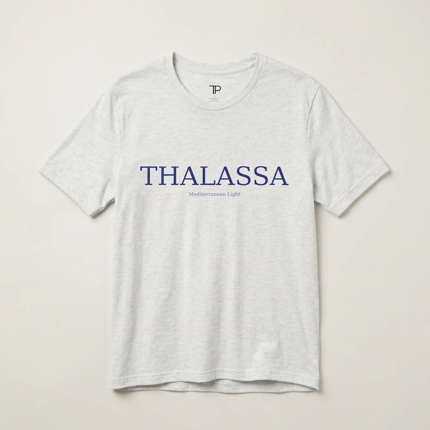 Gray t-shirt with 'THALASSA' text on a beige background