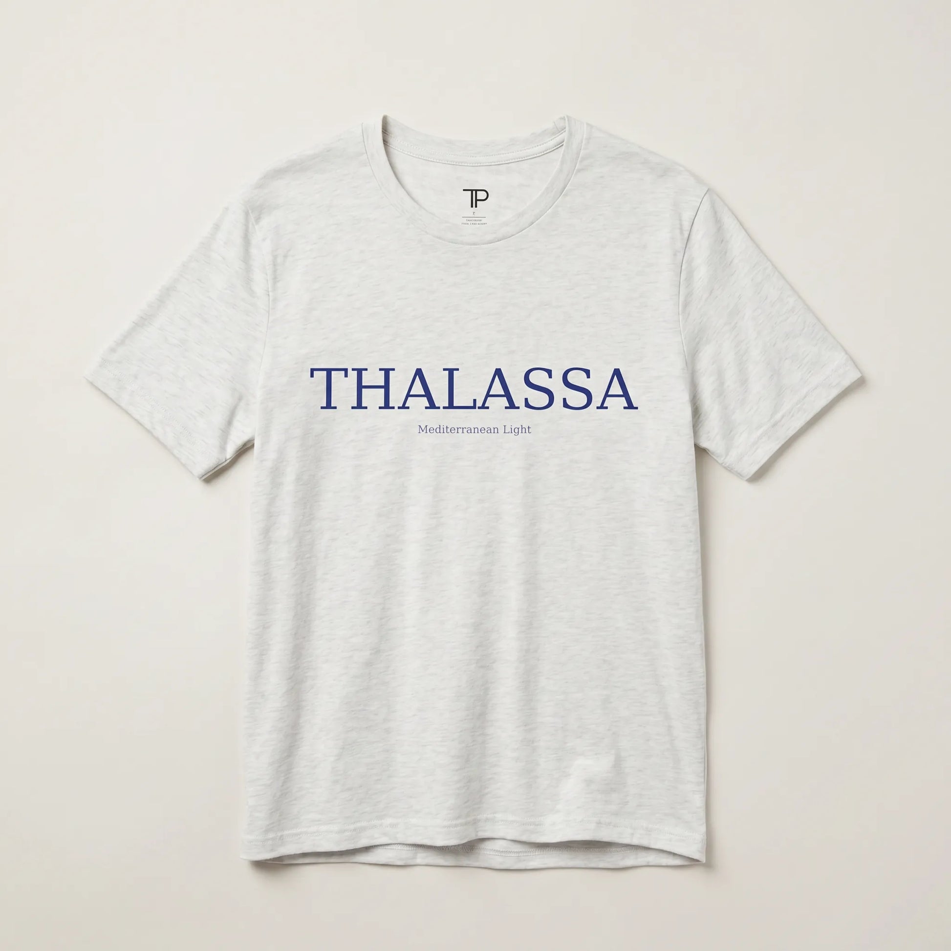 Gray t-shirt with 'THALASSA' text on a beige background