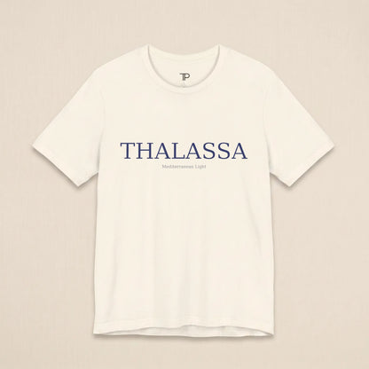 White t-shirt with 'THALASSA' text on a beige background