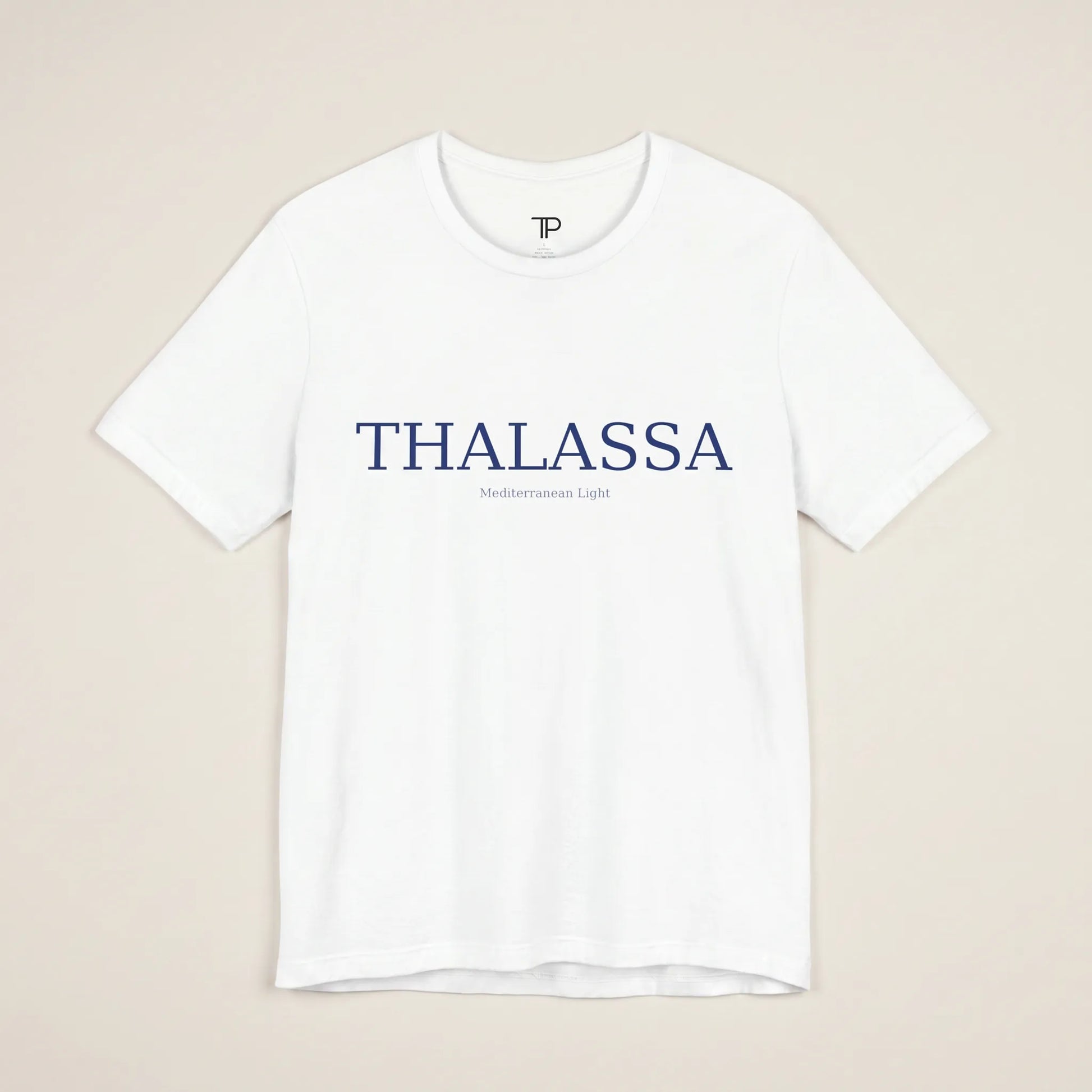 White t-shirt with 'THALASSA' text on a beige background