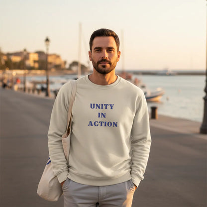 Model wearing Unity in Action embroidered hoodie during a calm Mediterranean evening walk by the sea