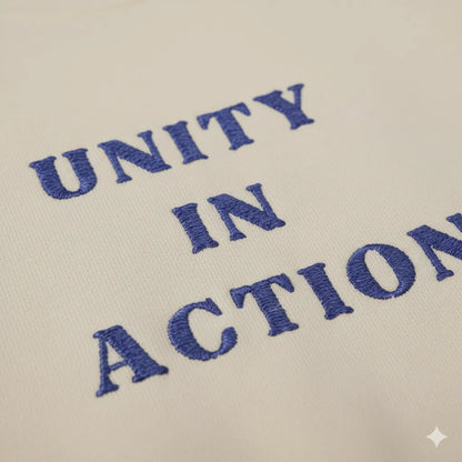 Close-up of Unity in Action solidarity slogan embroidery on unisex hoodie fabric