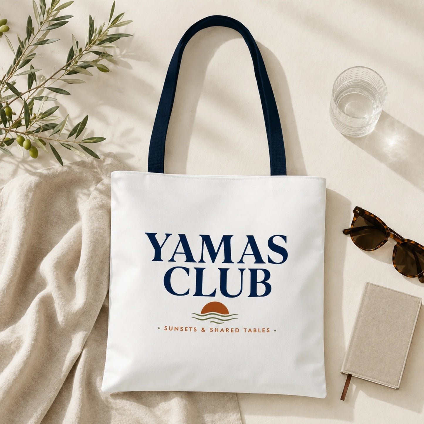 White tote bag with 'Yamas Club' text and logo on a light background