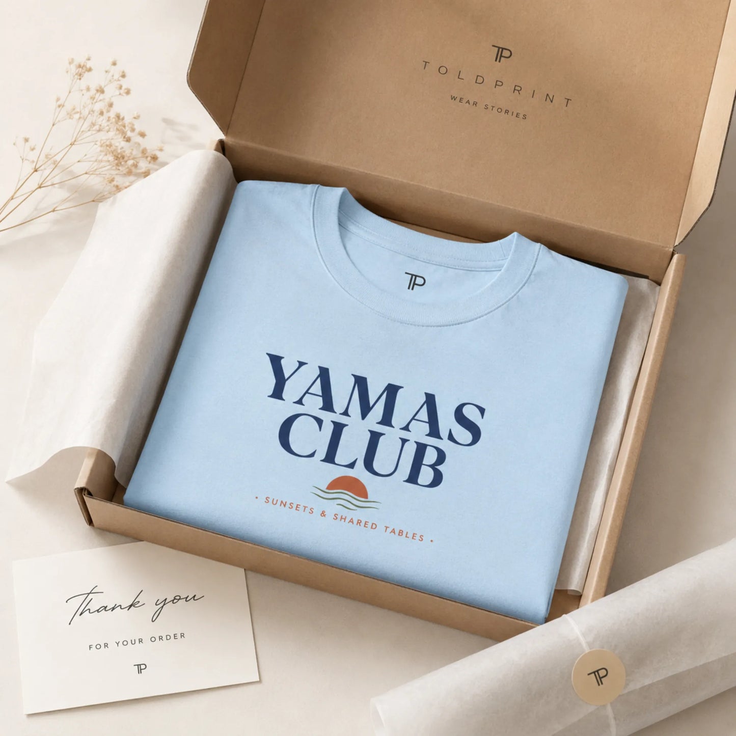 Light blue t-shirt with 'Yamas Club' text in a brown box, featuring Toldprint branding.
