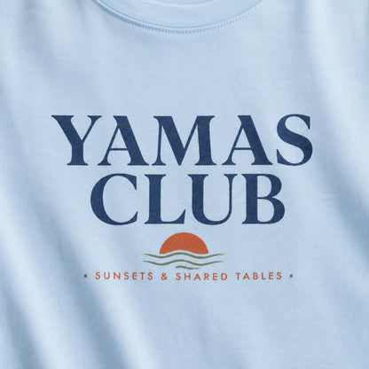 Light blue t-shirt with 'Yamas Club' text and sunset design on a white background